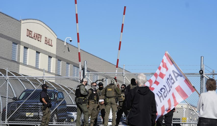 Protesters and security stand in front of Delaney Hall, a recently re-opened immigration detention center, in Newark, N.J., Wednesday, May 7, 2025. (AP Photo/Seth Wenig)