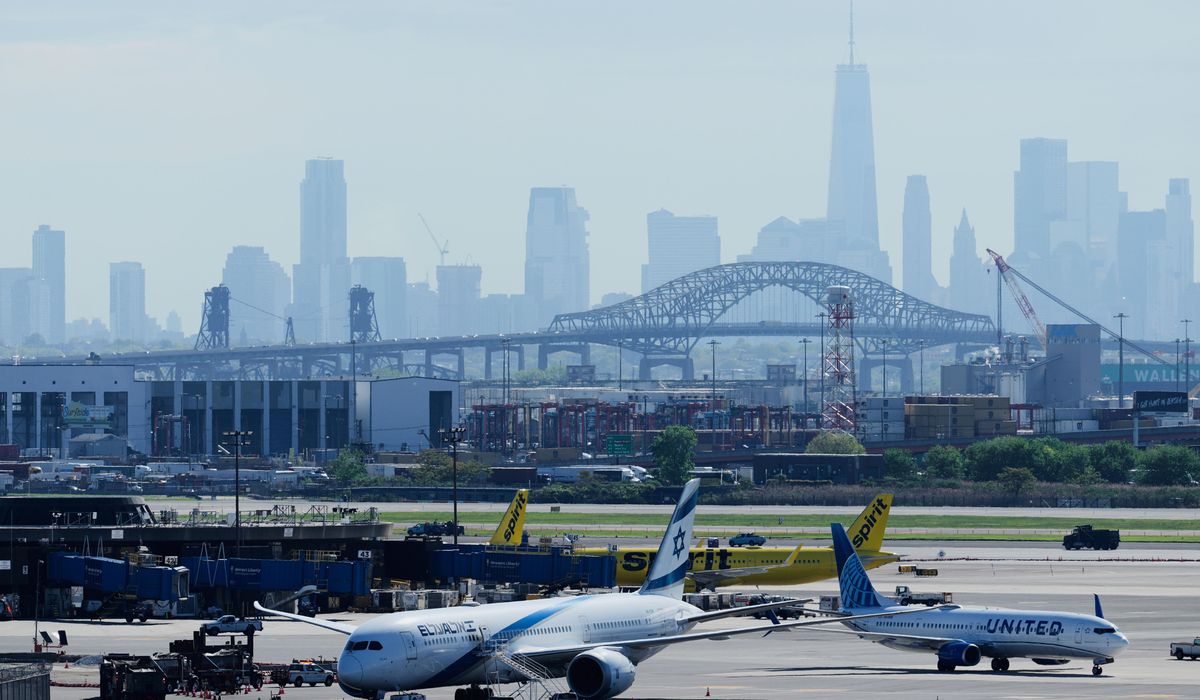 NextImg:Bag boy: Toddler takes a ride on the luggage conveyor belt at Newark Airport