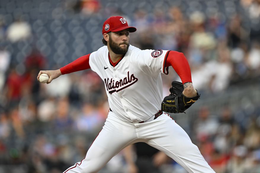 Washington Nationals pitcher Trevor Williams (32) throws during the third inning of a baseball game against the Chicago Cubs in Washington, Tuesday, June 3, 2025. (AP Photo/Terrance Williams)