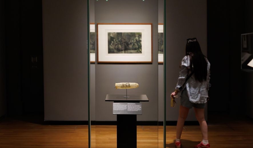 This image made available by the Rijksmueum shows a condom with print, circa 1830, displayed at Amsterdam's Rijksmuseum. (Kelly Schenk/Rijksmuseum via AP)