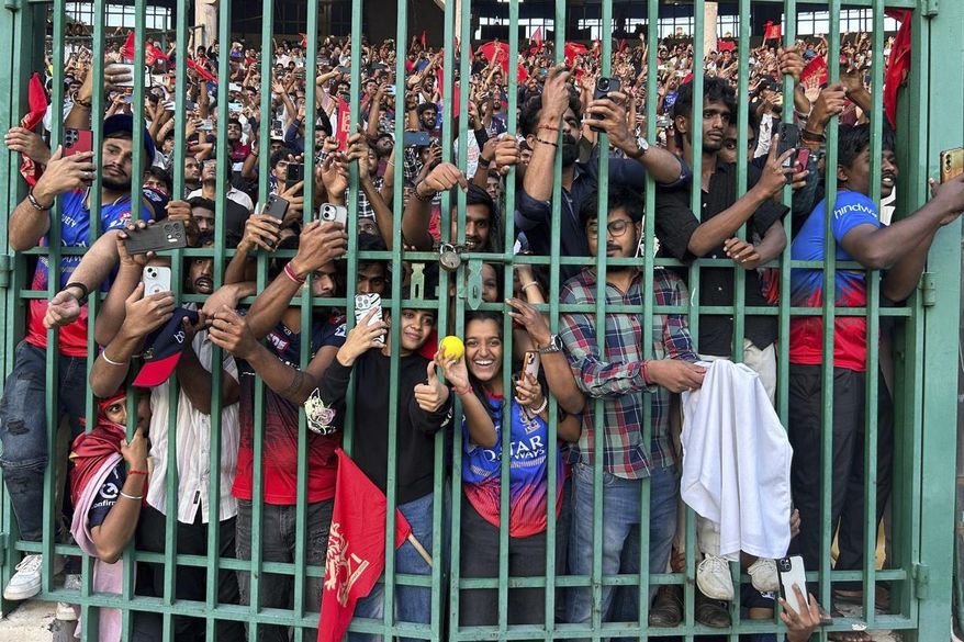 Fans gather to celebrate Royal Challengers Bengaluru cricketers, winners of the Indian Premier League, at the M. Chinnaswamy Stadium in Bengaluru, India, Wednesday, June 4, 2025. (AP Photo/Aijaz Rahi)