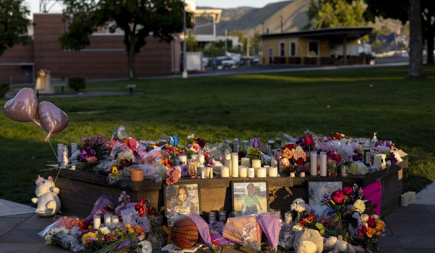 Pictures, flowers and candles mark a makeshift memorial Tuesday, June 3, 2025, in Wenatchee, Wash., in honor of Olivia, Paityn and Evelyn Decker, who were found dead near Leavenworth after their father Travis Decker failed to return them after a scheduled visitation. (Nick Wagner/The Seattle Times via AP)