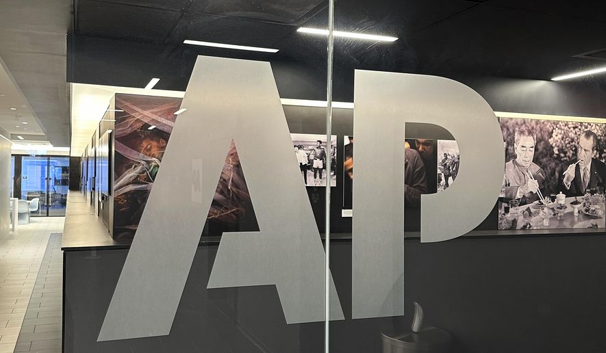 The Associated Press logo is displayed at the news organization's world headquarters in New York on April 9, 2025. (AP Photo/Aaron Jackson) **FILE**