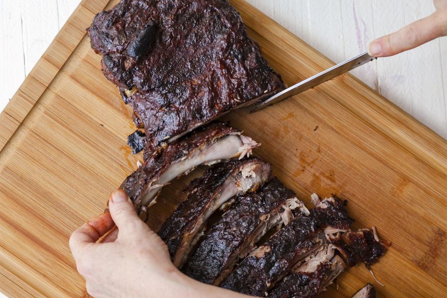A recipe for sticky Cajun ribs is prepared on a cutting board in New York on June 30, 2019 (Carrie Crow via AP)