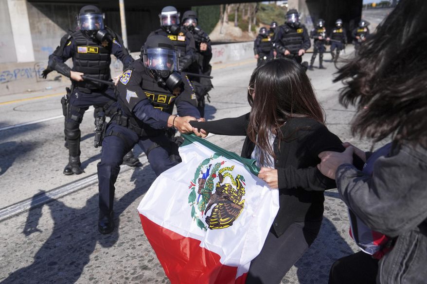 Protesters confront police on the 101 Freeway near the metropolitan detention center of downtown Los Angeles on Sunday, June 8, 2025, following the previous night's immigration raid protest. (AP Photo/Jae C. Hong) **FILE**