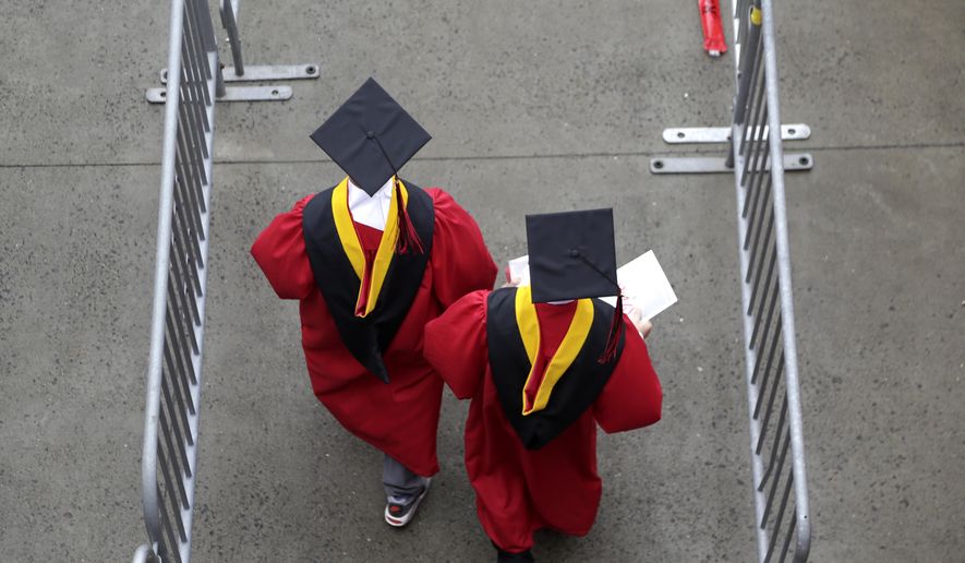 Graduates walk into the High Point Solutions Stadium before the start of the Rutgers University graduation ceremony in Piscataway Township, N.J., on May 13, 2018. (AP Photo/Seth Wenig) **FILE**