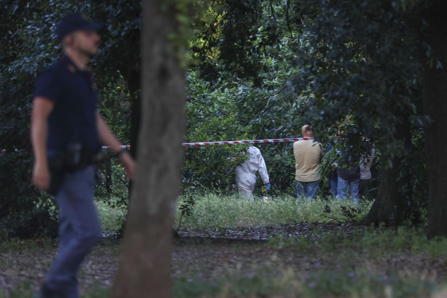 A police officer walks past a sealed off area where forensic police work at the site of the discovery of the body of an infant and the infant’s mother, in Rome’s Villa Pamphili park, Saturday, June 7, 2025. (Francesco Benvenuti/LaPresse via AP)