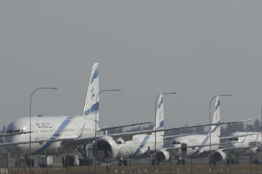 A row of aircrafts belonging to Israeli airlines El Al sit parked along the apron of Cyprus' main airport in Larnaca, Saturday, June 14, 2025. (AP Photo/Petros Karadjias)