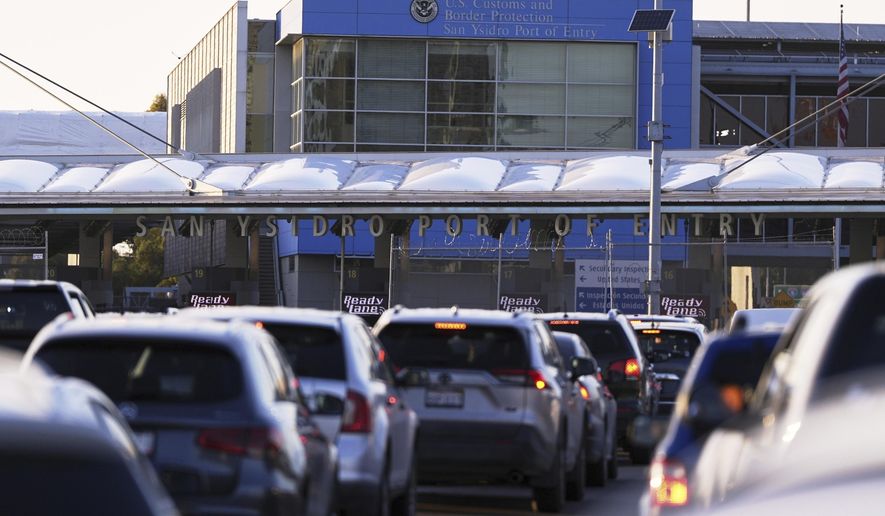 Vehicles wait in line to cross the border into the United States at the San Ysidro Port of Entry, March 18, 2025, in Tijuana, Mexico. (AP Photo/Gregory Bull) **FILE**