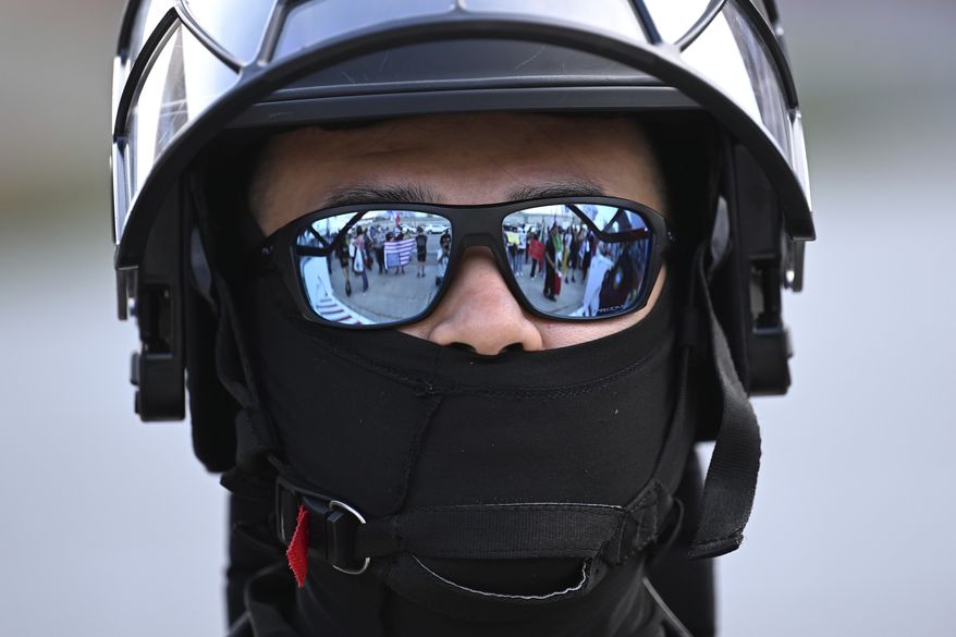 A U.S. Customs and Border Patrol agent looks on during a protest outside the Federal Building on Friday, June 13, 2025, in Los Angeles. (AP Photo/Wally Skalij)