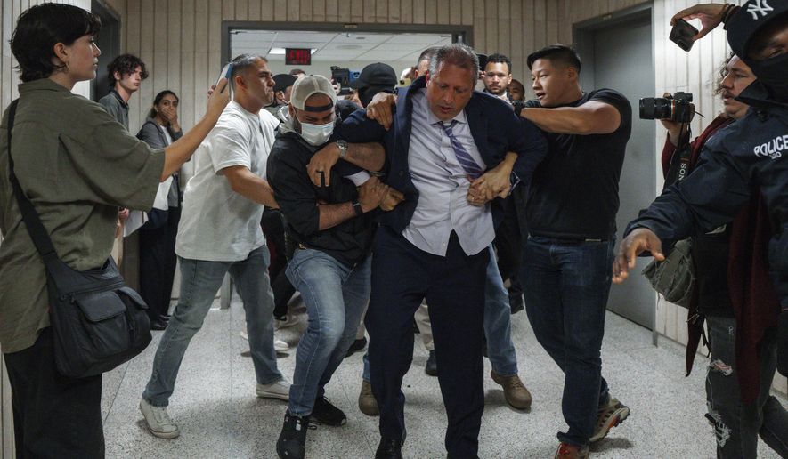 New York City Comptroller Brad Lander is placed under arrest by Immigration and Customs Enforcement (ICE) and FBI agents outside federal immigration court on Tuesday, June 17, 2025, in New York. (AP Photo/Olga Fedorova)