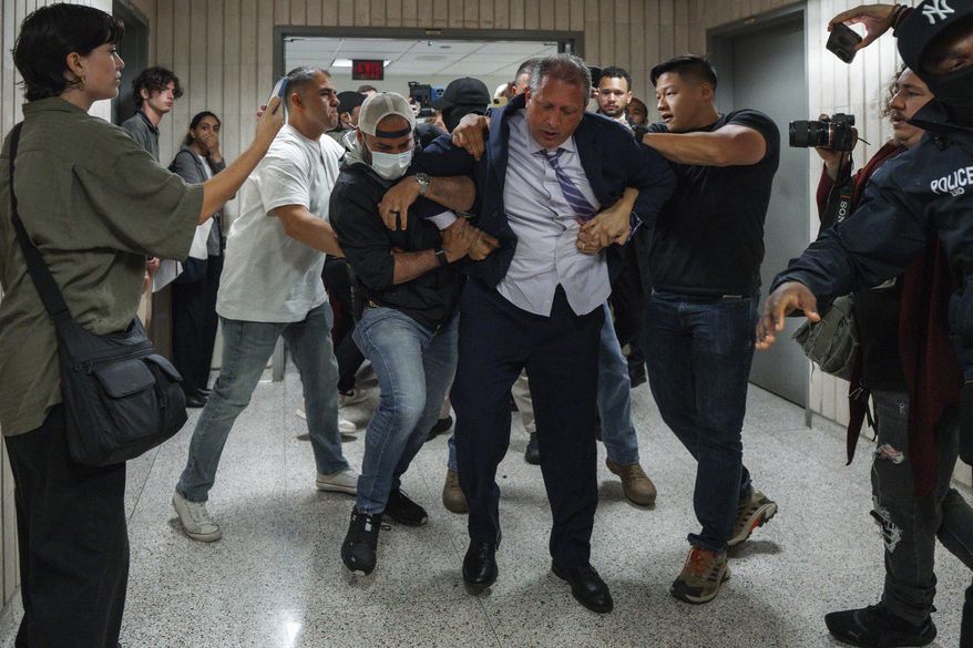 New York City Comptroller Brad Lander is placed under arrest by Immigration and Customs Enforcement (ICE) and FBI agents outside federal immigration court on Tuesday, June 17, 2025, in New York. (AP Photo/Olga Fedorova)