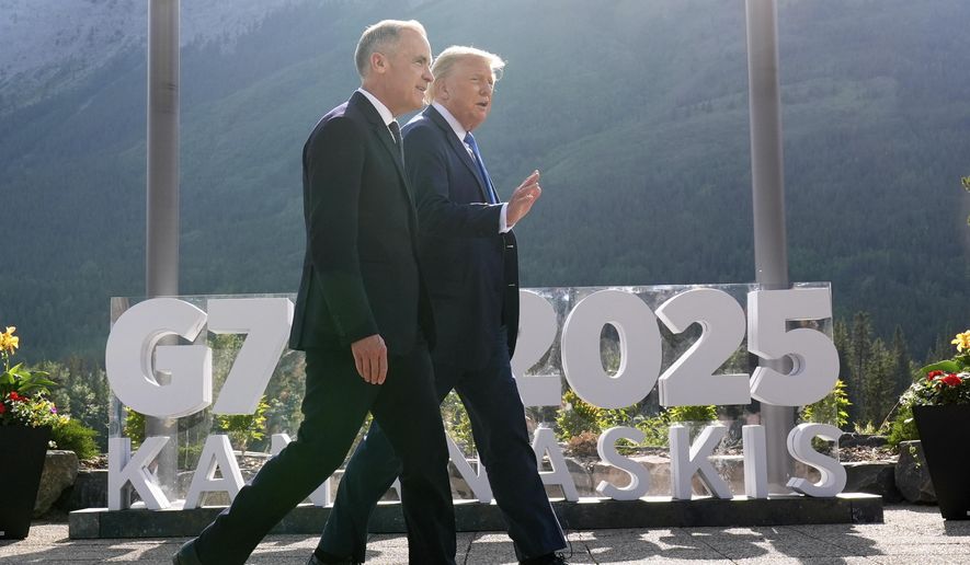 Canada's Prime Minister Mark Carney walks with President Donald Trump after a group photo at the G7 Summit, Monday, June 16, 2025, in Kananaskis, Canada. (AP Photo/Mark Schiefelbein)