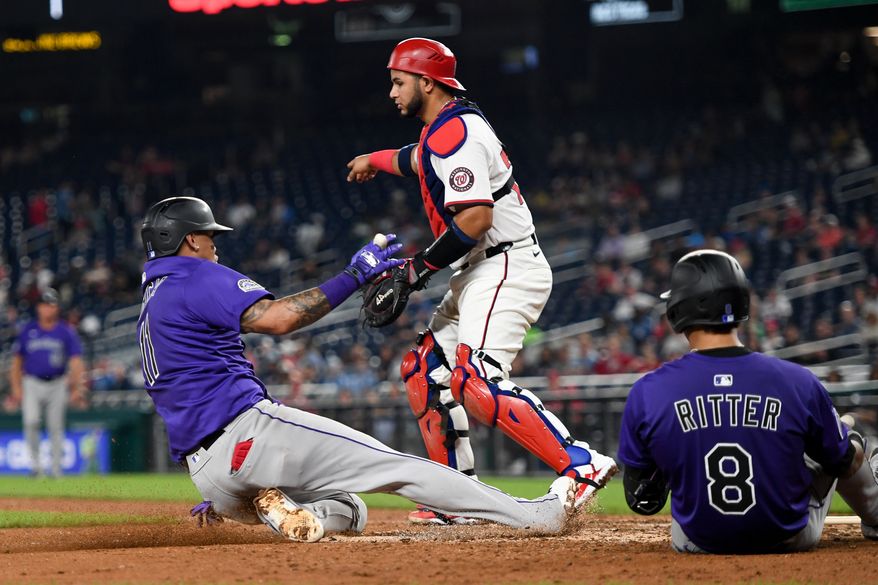 Colorado Rockies third baseman Orlando Arcia (11) sliding into home and scoring on Ryan Ritter’s (8) sacrifice bunt during the seventh inning of an MLB game against the Washington Nationals at Nationals Park in Washington D.C., June 18, 2025. (Photo by All-Pro Reels for Washington Times Sports)