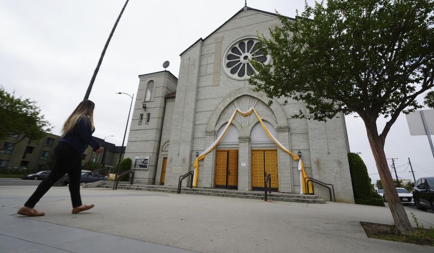 Melyssa Rivas walks outside a location where she witnessed masked federal agents detaining a person earlier this month outside Our Lady of Perpetual Help Catholic Church in Downey, Calif., on Friday, June 20, 2025. (AP Photo/Damian Dovarganes) **FILE**