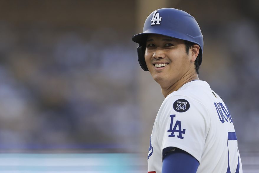 Los Angeles Dodgers designated hitter Shohei Ohtani reacts on base during the first inning of a baseball game against the Washington Nationals in Los Angeles, Friday, June 20, 2025. (AP Photo/Jessie Alcheh)