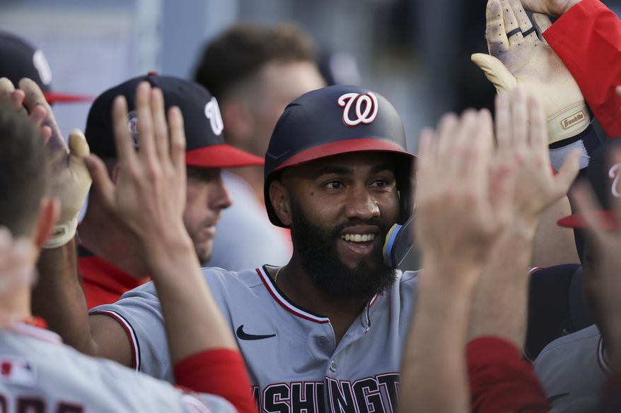Washington Nationals' Amed Rosario celebrates with teammates in the dugout after hitting a home run during the first inning of a baseball game against the Los Angeles Dodgers in Los Angeles, Friday, June 20, 2025. (AP Photo/Jessie Alcheh)