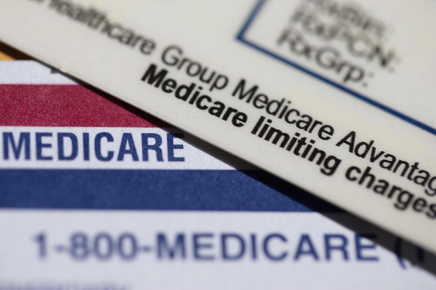 A Medicare Advantage PPO card rests on top of a Medicare card in Portland, Ore., June 10, 2024. (AP Photo/Jenny Kane, File)