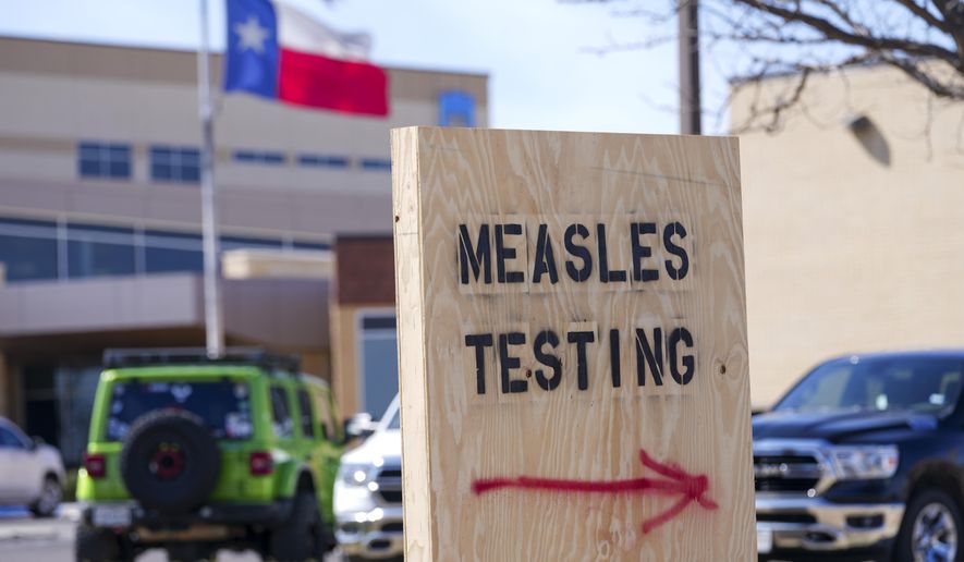 A sign is displayed outside the Seminole Hospital District offering measles testing, Feb. 21, 2025, in Seminole, Texas. (AP Photo/Julio Cortez, File)