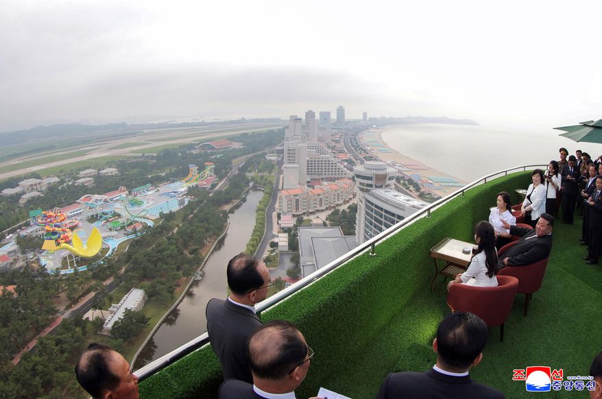In this photo provided by the North Korean government, North Korean leader Kim Jong-un, sitting center, with his wife Ri Sol-ju, rear, and daughter tour the Wonsan-Kalma coastal tourist zone in North Korea Tuesday, June 24, 2025. Independent journalists were not given access to cover the event depicted in this image distributed by the North Korean government. The content of this image is as provided and cannot be independently verified. Korean language watermark on image as provided by source reads: "KCNA" which is the abbreviation for Korean Central News Agency. (Korean Central News Agency/Korea News Service via AP)
