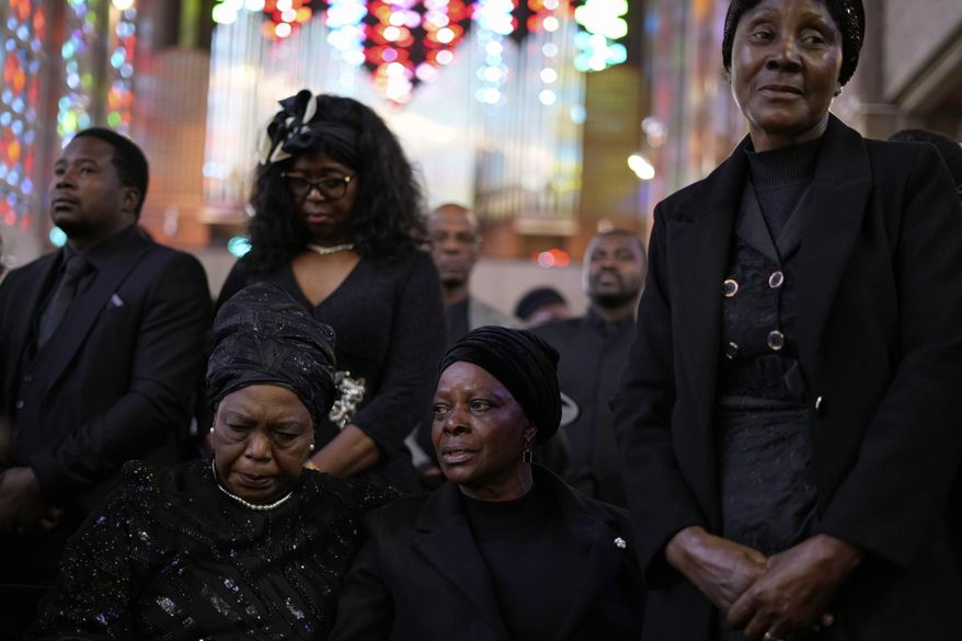 Esther Lungu, widow of Zambia's former President Edgar Lungu, center, and family members attend a Mass, at the Cathedral of Christ the King, in Johannesburg, South Africa, Wednesday, June 25, 2025. (AP Photo/Themba Hadebe)