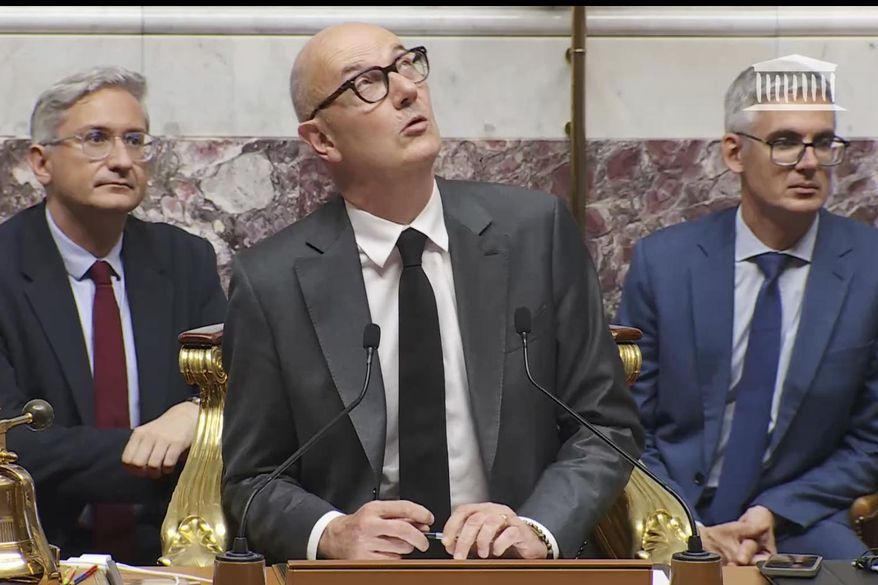This video image provided Thursday June 26, 2025 by the National Assembly shows the assembly vice president, Roland Lescure looking up as the domed ceiling leaks during torrential storms in Paris, Wednesday, June 25, 2025. (Assemblée Nationale via AP)