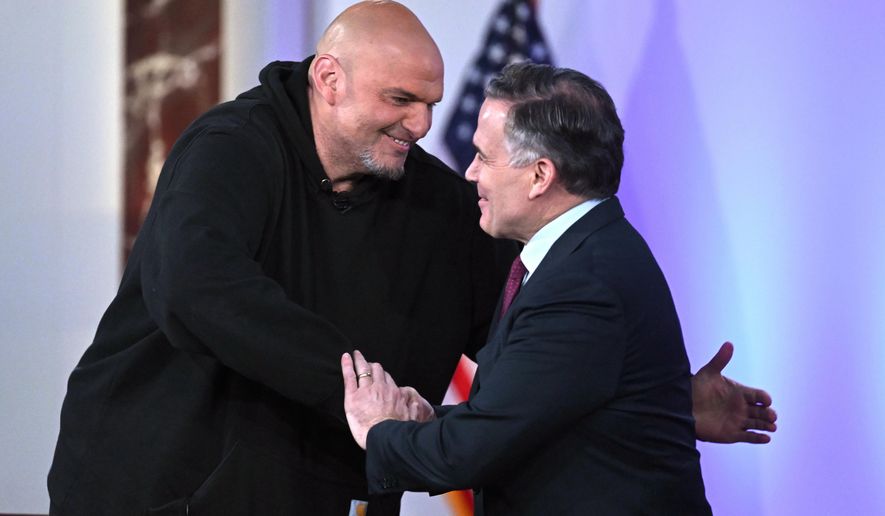 Sen. John Fetterman, D-Pa., left, and Sen. Dave McCormick, R-Pa., right, greet before participating in a debate moderated by Fox News anchor Shannon Bream, not shown, Monday, June 2, 2025, at the Edward M. Kennedy Institute for the United States Senate, Monday, June 2, 2025, in Boston, as livestreamed on Fox Nation. (AP Photo/Steven Senne)