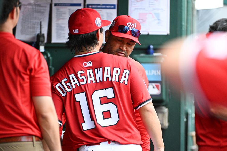 Washington Natioanls starting pitcher Shinnosuke Ogasawara (16) hugging manager Dave Martinez (4) in the dugout before the start of an MLB game against the Boston Red Sox at Nationals Park in Washington D.C., July 6, 2025. (Photo by All-Pro Reels for Washington Times Sports)