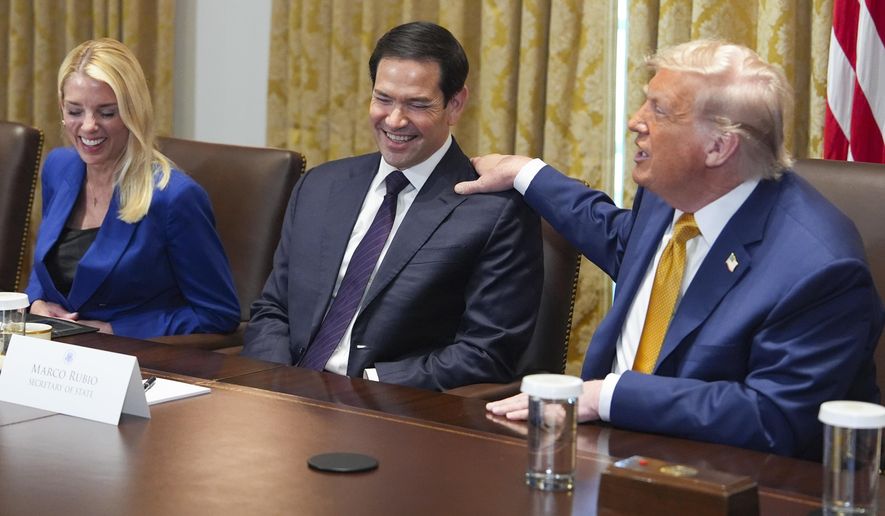 President Donald Trump, right, puts his hand on shoulder of Secretary of State Marco Rubio, center, as Attorney General Pam Bondi, left, looks on during a cabinet meeting at the White House, Tuesday, July 8, 2025, in Washington. (AP Photo/Evan Vucci)