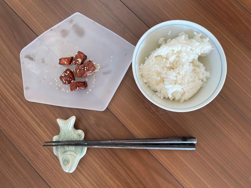 A plate of tuna tsukudani, served with hot rice, appears in the Tsukuda neighborhood of Tokyo, Monday, June 30, 2025. (AP Photo/Yuri Kageyama)