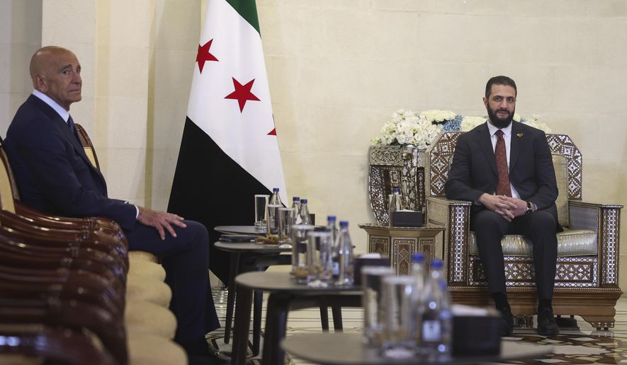 Syria's interim president, Ahmad al-Sharaa, right, meets with U.S. Ambassador to Turkey and Special Envoy to Syria Tom Barrack at the People's Palace in Damascus, Syria, Wednesday, July 9, 2025. (AP Photo/Ghaith Alsayed)