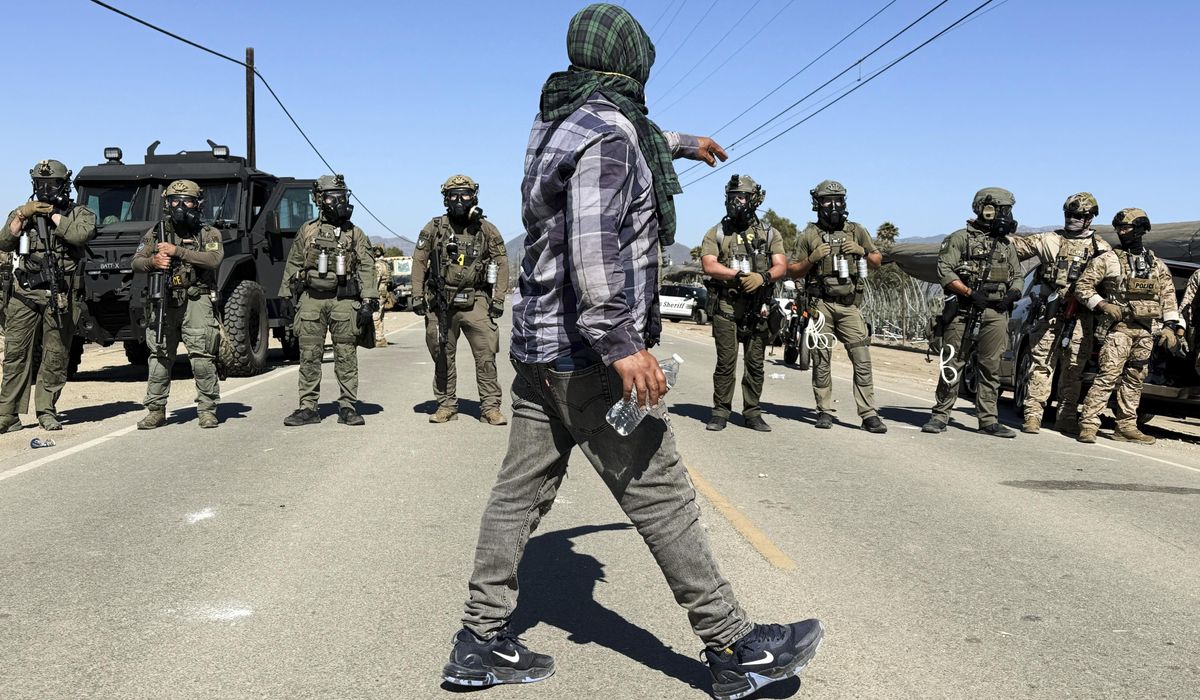 NextImg:Protesters, ICE agents clash during raid at California farm