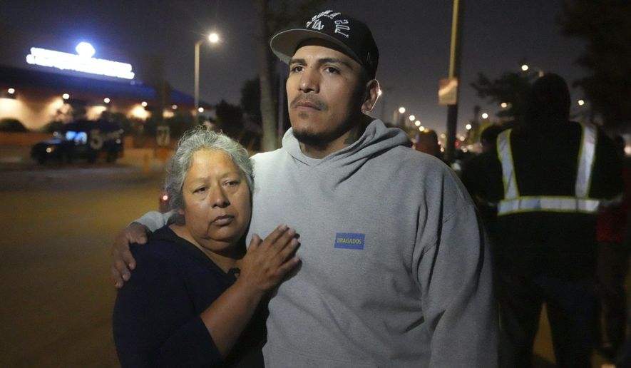 Maria Orozco hugs her son, Oraldo Orozco, one of her three sons who were trapped as tunnel workers inside a collapsed tunnel under construction for Los Angeles County's Clean Water project, Wednesday, July 9, 2025, in Los Angeles. (AP Photo/Damian Dovarganes)