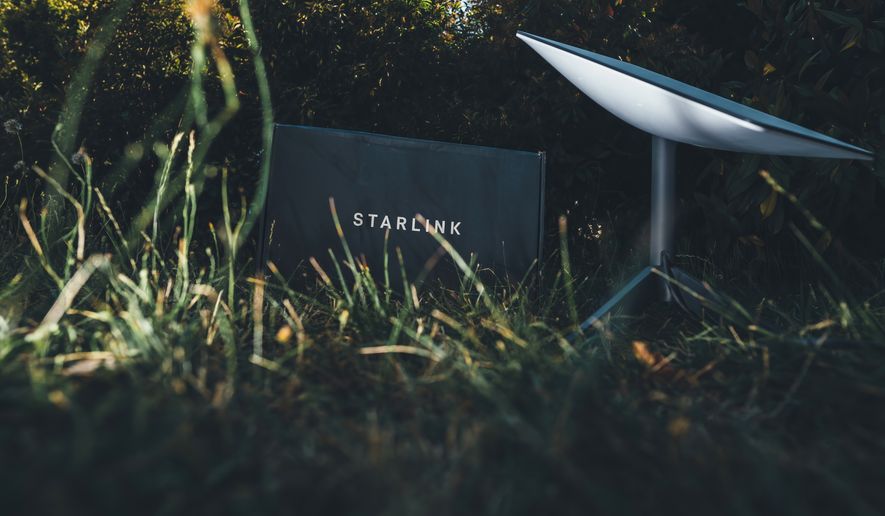 Starlink system from SpaceX being unboxed in backyard garden, Germany - Jun 16, 2023. File photo credit: Hadrian via Shutterstock.