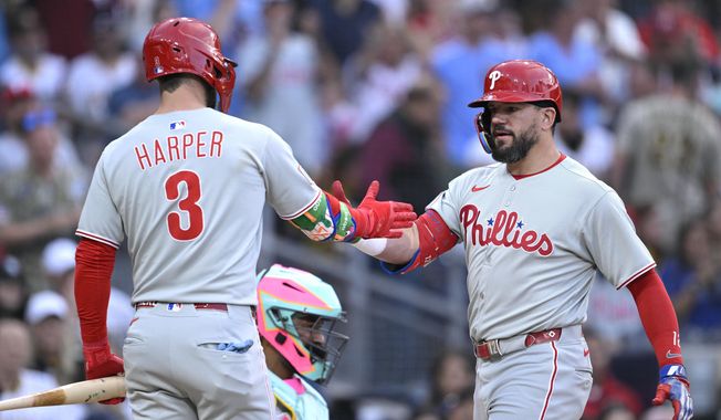 Philadelphia Phillies' Kyle Schwarber, right, is congratulated by Bryce Harper after hitting a home run during the third inning of a baseball game against the San Diego Padres, Friday, July 11, 2025, in San Diego. (AP Photo/Orlando Ramirez)
