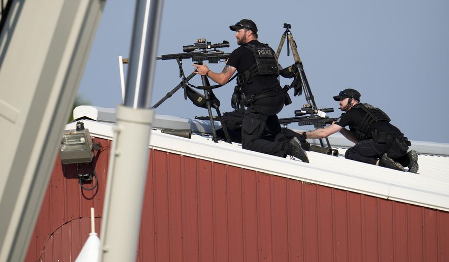 Police snipers return fire after shots were fired while Republican presidential candidate former President Donald Trump was speaking at a campaign event in Butler, Pa., July 13, 2024. (AP Photo/Gene J. Puskar, File)