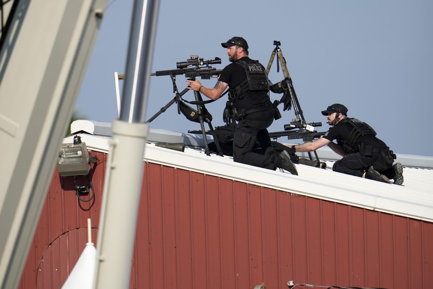 Police snipers return fire after shots were fired while Republican presidential candidate former President Donald Trump was speaking at a campaign event in Butler, Pa., July 13, 2024. (AP Photo/Gene J. Puskar, File)
