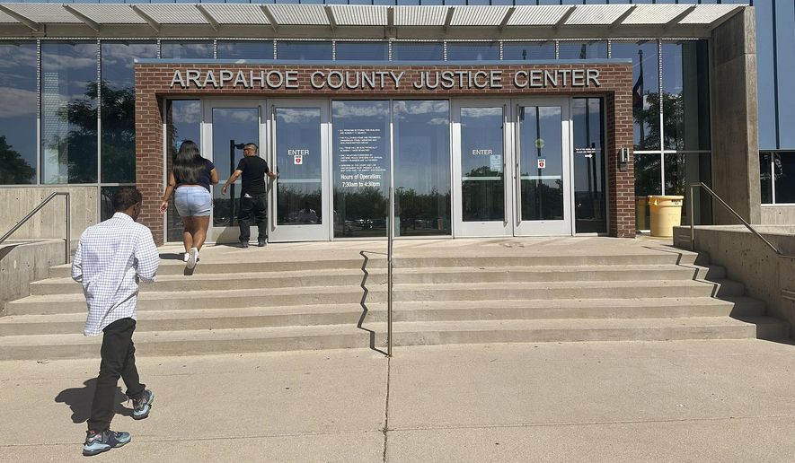 People enter the Arapahoe County Justice Center in Centennial, Colo., on Monday, July 14, 2025. (AP Photo/Thomas Peipert)