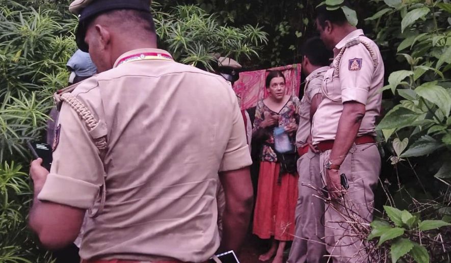 Indian policemen rescue Nina Kutina, 40, a Russian woman, from a cave in forest area of Ramtirtha hills in southern Indian state of Karnataka, Wednesday, July 9, 2025. (Uttara Kannada District Police via AP)