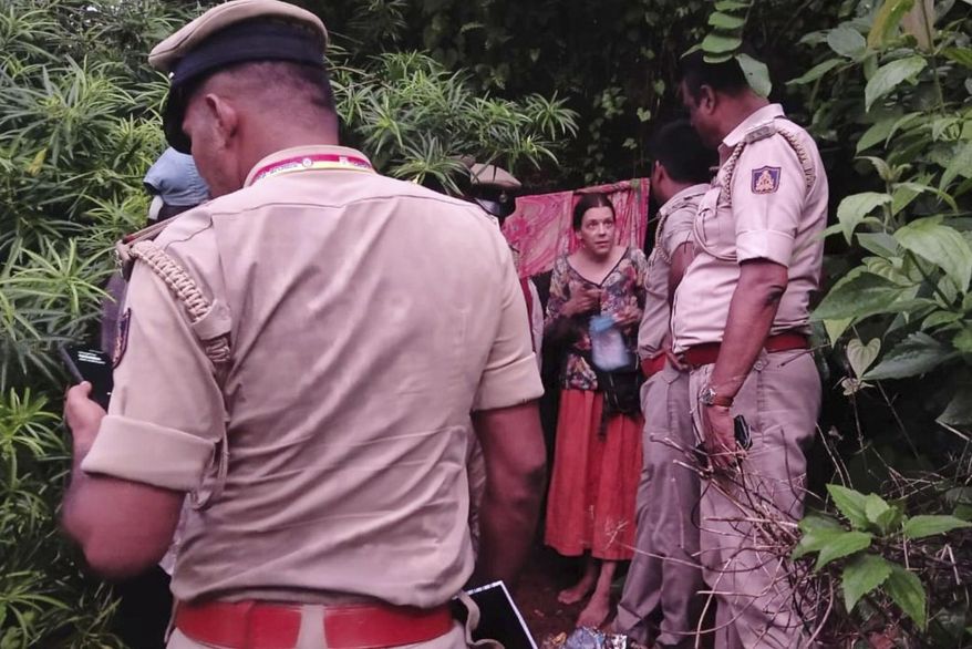 Indian policemen rescue Nina Kutina, 40, a Russian woman, from a cave in forest area of Ramtirtha hills in southern Indian state of Karnataka, Wednesday, July 9, 2025. (Uttara Kannada District Police via AP)