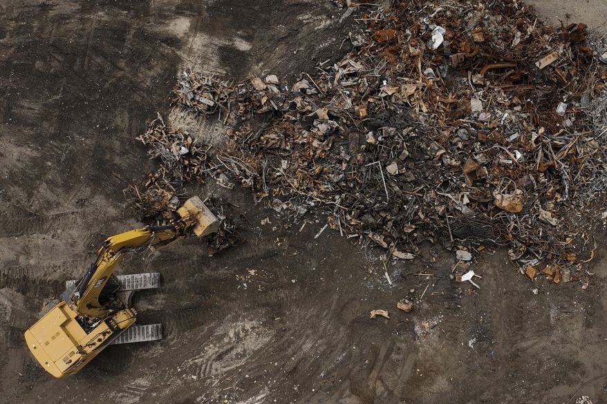 Debris from January wildfires is processed at a recycling facility set up on a golf course in Altadena, Calif., Wednesday, June 4, 2025. (AP Photo/Jae C. Hong)