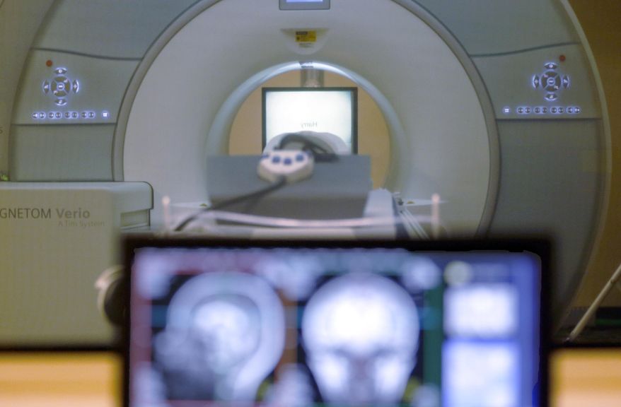 A brain-scanning MRI machine is seen in Pittsburgh, Nov. 26, 2014. (AP Photo/Keith Srakocic, File)