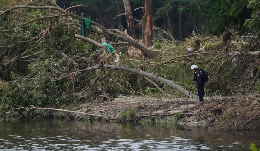 Search and rescue teams comb the banks of the Guadalupe River after a flash flood swept through the area, Saturday, July 12, 2025, in Kerrville, Texas. (AP Photo/Eric Gay, File)