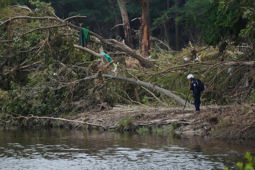 Search and rescue teams comb the banks of the Guadalupe River after a flash flood swept through the area, Saturday, July 12, 2025, in Kerrville, Texas. (AP Photo/Eric Gay, File)