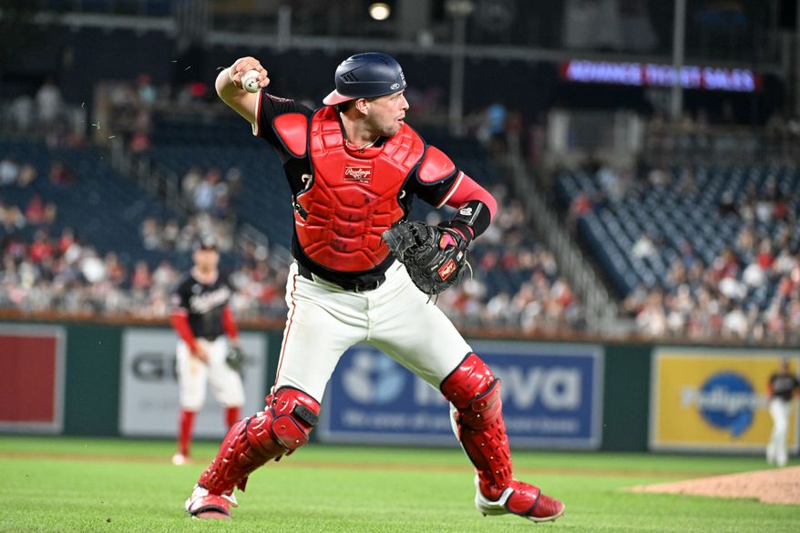 Washington Nationals catcher Riley Adams (15) making the throw to first after fielding a ground ball off the bat of Cincinnati Reds centerfielder TJ Friedl (29) during the eighth inning of an MLB game at Nationals Park in Washington D.C., July 21, 2025. (Photo by All-Pro Reels for Washington Times Sports)
