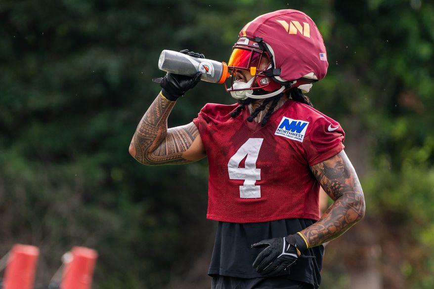 Washington Commanders Line Backer Frankie Luvu (4) hydrates at Commanders training camp at the OrthoVirginia Training Center in Ashburn, Virginia, July 23rd, 2025. (Photo by Jordan Sabillo for Washington Times)