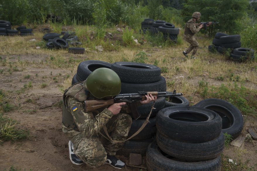 Ukrainian military recruits train at the polygon in the Kyiv region, Ukraine, Wednesday, July 16, 2025. (AP Photo/Evgeniy Maloletka)