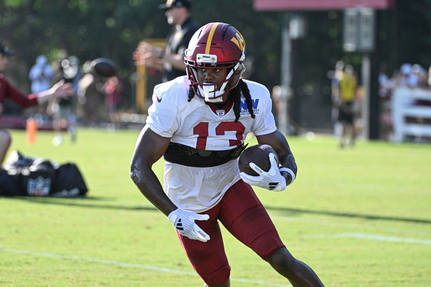 Washington Commanders wide receiver K.J. Osborn (13) running with the ball after catching a pass during Monday morning’s training camp session at the OrthoVirginia Training Center at Commanders Park in Ashburn, VA, July 28, 2025 (Photo for the Washington Times)