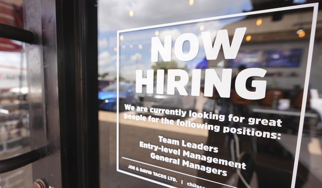 A sign announces a restaurant is hiring workers, Tuesday, July 15, 2025, in Richardson, Texas. (AP Photo/LM Otero) ** FILE **