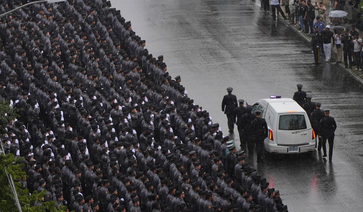 NextImg:Mourners honor the NYPD officer killed in the attack at the NFL headquarters building